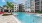 The pool area at our luxury 55+ apartments in Lakewood Ranch, FL, featuring lounge chairs and umbrellas.